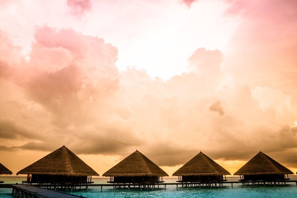 Over water bungalows in Tahiti with steps into amazing green lagoon. Best Honeymoon Destinations